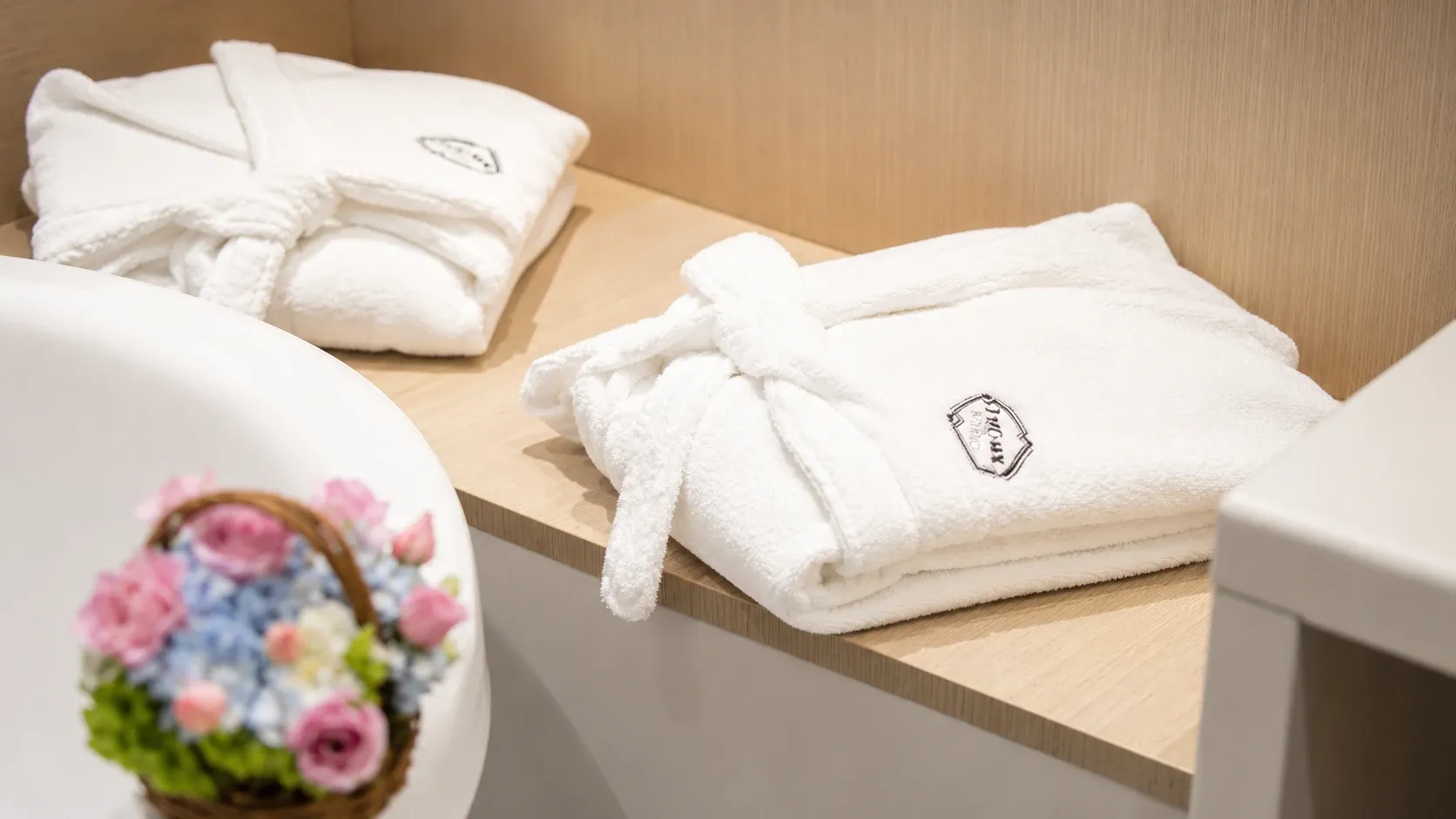 Bathrobe in the Vintage Tub Suite and king-size bed at Hotel Punto MX.