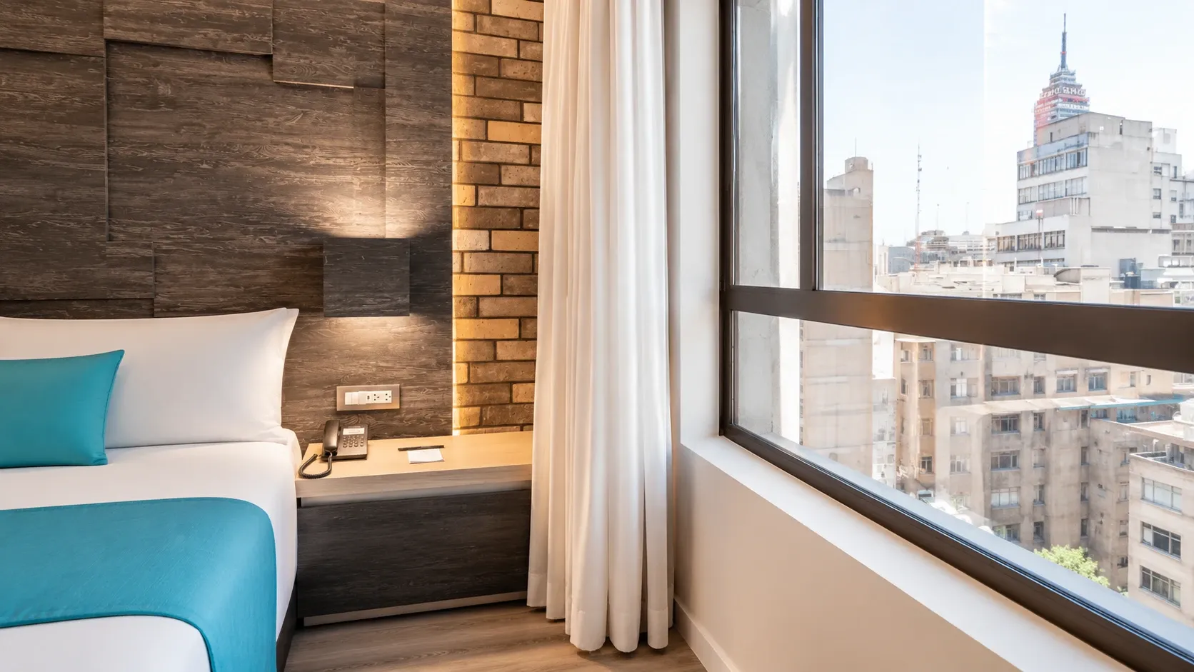 View of the Vintage Tub Suite and king-size bed at Hotel Punto MX.
